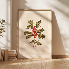 a christmas holly print hangs on the wall next to books and a potted plant