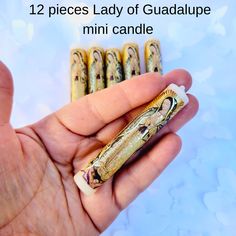 a hand holding some tiny candles in it's palm with the text 12 pieces lady of guadalupe mini candle