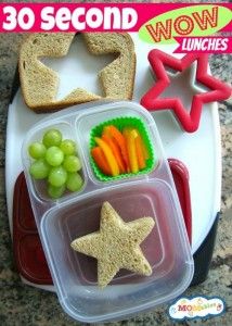 there is a lunch box with food in it and star shaped cutters on the plate