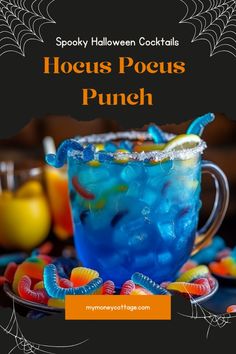 a blue drink in a glass with candy on the rim and spooky halloween cocktails