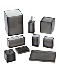 black and white bathroom accessories including soap dispenser, tissue dispenser, toothbrush holder