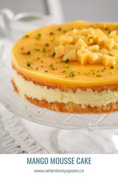 a cheesecake on a glass plate with the words mango mousse cake above it