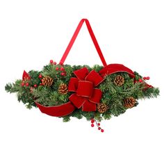 a christmas wreath with red ribbon and pine cones hanging from the side, decorated with lights