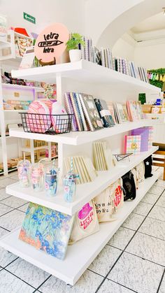 the shelves are filled with books and magazines