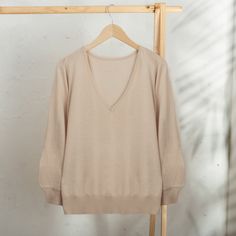 With fully-fashioned three-quarter length sleeves and a V-neck, this pullover is perfect for all occasions and will become an essential item. Peru's Violeta Pacheco knits it from a cotton blend in a solid beige hue. Beige Long Sleeve V-neck Sweater For Loungewear, Beige Long Sleeve V-neck Sweater For Layering, Spring Beige V-neck Sweater, Beige Cotton V-neck Sweater, Cotton Sweater With 3/4 Sleeve For Fall, Beige V-neck Sweater For Loungewear, Casual Beige Fine Knit V-neck Sweater, Beige V-neck Cotton Knit Top, Casual Beige 3/4 Sleeve Cardigan