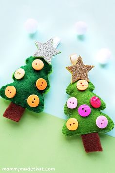 two felt christmas trees with buttons on them