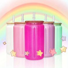 three different colors of water bottles with stars on the side and rainbow in the background