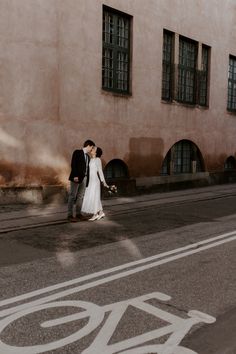 a newly married couple walking down the street