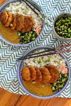 two bowls filled with rice and meat on top of a table