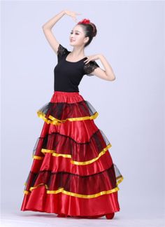 a woman wearing a red and black dress with yellow trims on the bottom skirt