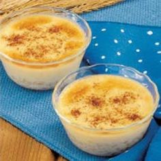 two small bowls filled with food on top of a blue towel