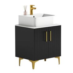 a bathroom vanity with a white sink and gold faucet on the top, next to a black cabinet