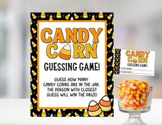 a candy corn game sitting on top of a table next to a glass bowl filled with candy