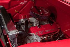 the engine compartment of an old red car