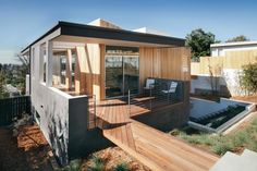 a small house with a wooden deck and patio