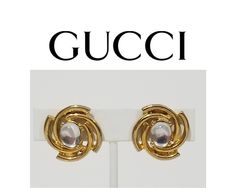 These gorgeous 80s clip-ons have gold tone metal spirals around clear cabochon glass pieces. They are marked PAOLO on both the backs and the rear of the earrings themselves, that's how you know they are authentic. They are the real deal. In like-new condition. Golden Spiral, Gucci Brand, Gucci Jewelry, Glass Pieces, Gold Tone Metal, Clip On Earrings, Etsy Earrings, Gold Tones, Jewelry Earrings