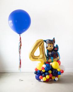 a birthday balloon with the number four on it and balloons in the shape of animals