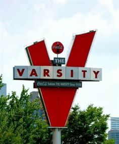 a red and white sign with the word varsity on it