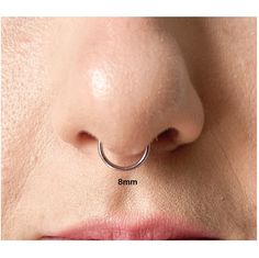 a woman's nose is shown with the size of her nose ring on it