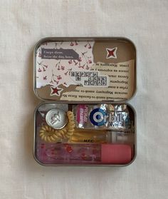 an open tin with various items in it