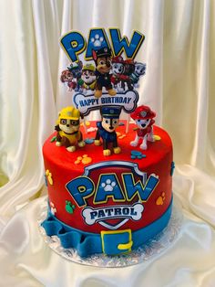 a birthday cake with paw patrol characters on it