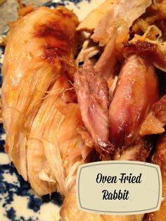 an open fried rabbit on a blue and white plate with the words oven fried rabbit