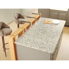 a kitchen counter top with chairs around it