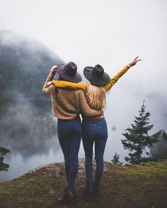 two people standing on top of a hill with their arms around each other and the caption reads instagram