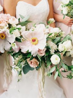 the bridesmaids are holding their bouquets with pink and white flowers