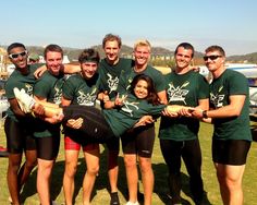 a group of people standing next to each other on top of a lush green field