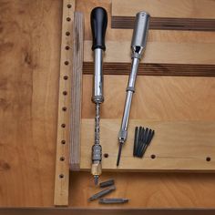 the tools are laying on top of the wooden drawer door and ready to be used