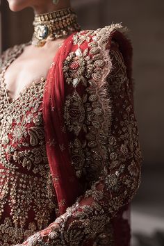 Pakistani Bridal Red Lehenga and Embellished Gown Dress is a stunning attire as it has all the qualities of a flawless Bridal dress. This stunning Pakistani Bridal Outfit is hand-embellished with mukaish, gold ornaments, and shimmering details, making this masterpiece an epitome of royalty and grace. Pakistani Bridal Gown: The beautiful Pakistani Bridal Gown in a stunning red shade comes in graceful open style and is intricately emblazoned with zardosi, resham, dabka, marori, and embroidery. Thi Red Dress For Wedding And Eid Celebration, Red Wedding Dress For Eid, Red Anarkali Dress For Wedding, Traditional Floor-length Gown With Intricate Embroidery, Traditional Floor-length Gown For Reception, Red Gown With Resham Embroidery For Eid, Red Bollywood Dress For Wedding, Red Organza Floor-length Gown, Festive Hand Embellished Gown With Traditional Drape