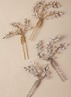 three bridal hair pins with pearls on them