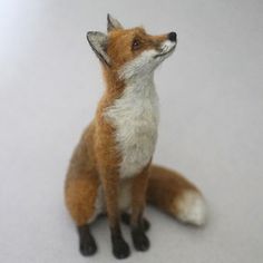 a toy fox sitting on top of a white table