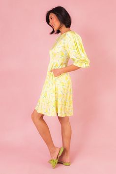 Introducing the Lita Dress, your sunny day delight straight from the orchard! Made from vibrant yellow, green, and white fruit-print satin fabric, this dress features a charming round neckline and 3/4 length puff sleeves with elastic closure, adding a playful touch to your summer wardrobe. With a knee-length skirt adorned with pockets and a hidden back zipper for easy wear, it's the perfect blend of style and practicality for picnics, brunches, and everything in between. Yellow Summer Dress With Fruit Print, Yellow Puff Sleeve Mini Dress With Floral Print, Pink Floral Print Knee-length Puff Sleeve Dress, V-neck Lemon Print Summer Dress, Yellow Floral Print Cotton Mini Dress, White Fruit, Short Satin Dress, City Woman, White Dress Party