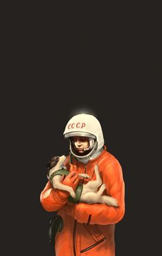 a man in an orange jacket holding a cat on his chest and wearing a white helmet