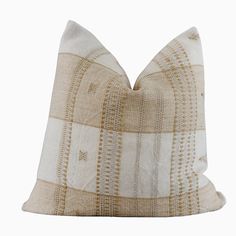 a beige and white striped pillow on a white background