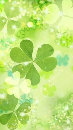 four leaf clovers on a green and white background with sparkling stars in the center