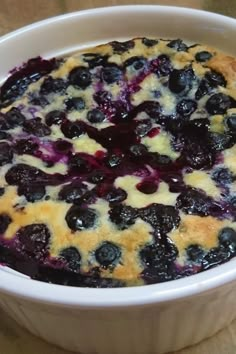 a blueberry cobbler in a white bowl on a table