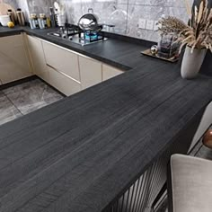 a kitchen with black counter tops and white cabinets