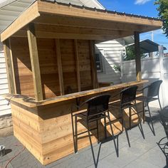 an outdoor bar with chairs and tables outside