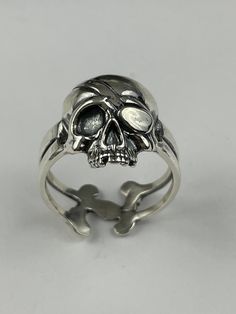 Elevate your style with our unique Silver Human Skull Statement Ring, a bold and edgy piece of gothic jewelry.  Key Features: - Handcrafted from high-quality silver, featuring a detailed human skull design that makes a striking statement - Gothic-inspired ring that adds a touch of edgy elegance to any outfit, perfect for those with a love for the macabre - Versatile design suitable for both men and women, making it a standout accessory for any occasion - Ideal as a gift for anyone who appreciate