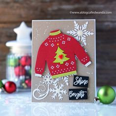 a handmade christmas card with a red sweater and snowflakes on the front