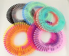 six different colored hair ties are arranged in a circle