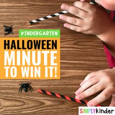 two children are playing with halloween paper straws and spider wands on the table