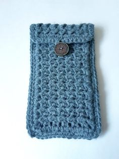 a crocheted blue case with a button on it