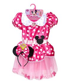 a pink minnie mouse dress with white polka dots