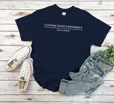 "Custom Law School Shirt, Customized University Tshirt Unisex for Mens and Women available in 10 color ; Black, White Navy, Sport Grey, Royal Blue, Irish Green, Red, Natural, Military Green, Dark Chocolate. This shirt using USA standard size; S, M, L, XL, 2XL, 3XL, 4XL. Tee Spec's Using Direct to Garment (DtG) for quality and durability print. Using semi-fitted tee full cotton for cool & comfort t-shirt. * 100% ring-spun cotton * Pre-shrunk for extra durability * Shoulder-to-shoulder taping * Quarter-turned to avoid crease down the center. Size Chart S 18\" with 28\" length M 20\" with 29\" length L 22\" with 30\" length XL 24\" with 31\" length 2XL 26\" with 32\" length 3XL 28\" with 33\" length 4XL 30\" with 34\" length 5XL 32\" with 35\" length Handling time After clearing payment, plea Branded Relaxed Fit T-shirt For College, Casual Cotton Shirt With Custom Logo, Custom Logo Crew Neck Tops For College, Crew Neck Top With Custom Logo For College, School Of Law, University Shirt, University Tshirt, Fitted Tee, Business Shirts