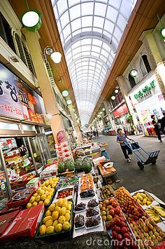 an indoor market filled with lots of fruits and vegetables