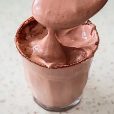 a chocolate drink with a spoon sticking out of it